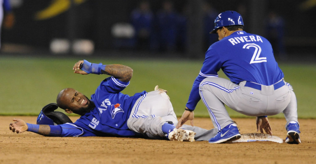 Toronto Blue Jays' Reyes reacts to the pain after hurting his ankle in the sixth inning against the Kansas City Royals at baseball game in Kansas City